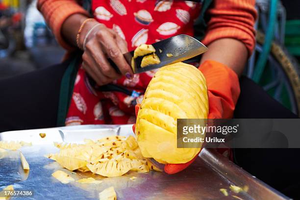preparing a fresh pineapple - pineapple cut stock pictures, royalty-free photos & images
