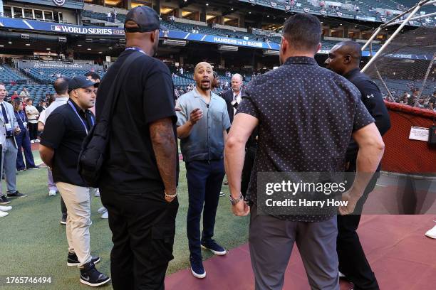 Mookie Betts of the Los Angeles Dodgers, serving as the MLB World Series correspondent, has a conversation on the field prior to Game Three of the...