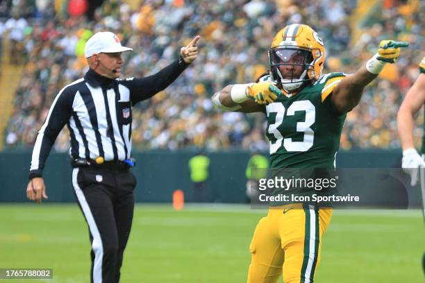 Green Bay Packers running back Aaron Jones and referee Clete Blakeman signal first down during a game between the Green Bay Packers and the Los...
