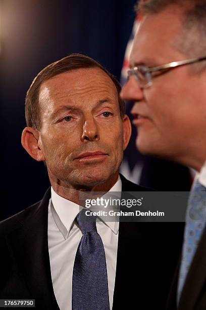 Coalition immigration spokesman Scott Morrison talks to the media as Opposition Leader Tony Abbott looks on at a press conference regarding policy on...