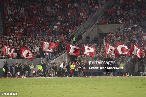 The North Carolina State Wolfpack cheerleaders run the Wolfpack signs during the college football game between the North Carolina State Wolfpack and...