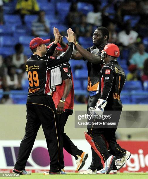 Ben Rohrer of Antigua Hawksbills gives Rahkeem Cornwall a high five for taking two St. Lucia Zouks wickets during the Seventeenth Match of the...