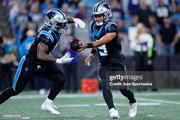 Carolina Panthers quarterback Bryce Young hands off to Carolina Panthers running back Miles Sanders in the third quarter of play during a NFL game...