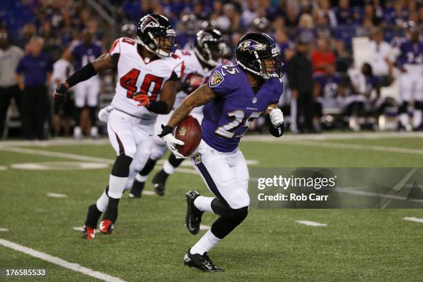 Asa Jackson of the Baltimore Ravens returns a punt for a touchdown as Troy Sanders of the Atlanta Falcons chases him during the second half of a...