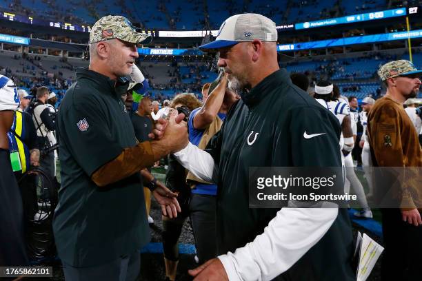 Carolina Panthers head coach Frank Reich shakes hands with Indianapolis Colts defensive coordinator Gus Bradley after a NFL game between the...