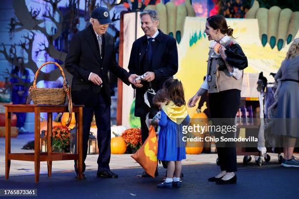 President Joe Biden greets Secretary of State Antony Blinken, his wife White House Cabinet Secretary Evan Ryan and their children during a Halloween...