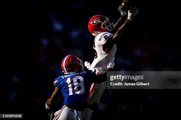 Dominic Lovett of the Georgia Bulldogs attempts to catch a pass against Bryce Thornton of the Florida Gators during the second half of a game at...