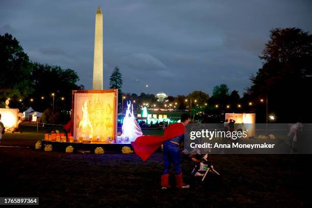 Trick-or-treaters run on the South Lawn of the White House during a Halloween event on October 30, 2023 in Washington, DC. U.S. President Joe Biden...