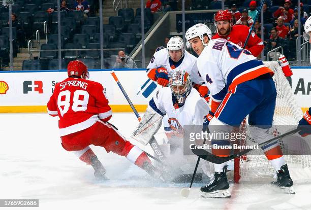 Ilya Sorokin of the New York Islanders makes the first period save as Daniel Sprong of the Detroit Red Wings looks for the rebound at UBS Arena on...