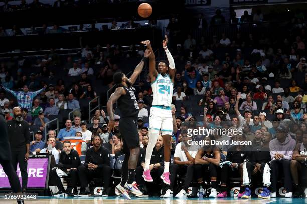 Brandon Miller of the Charlotte Hornets shoots a three pointer over Royce O'Neale of the Brooklyn Nets during the first half of an NBA game at...