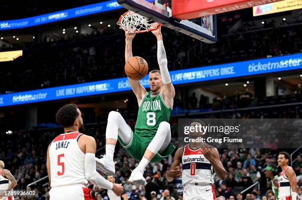 Kristaps Porzingis of the Boston Celtics dunks the ball in the first quarter against the Washington Wizards at Capital One Arena on October 30, 2023...