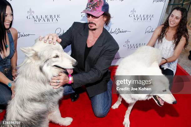 Actor David Fralick poses for a photo with Ranger a wolf from the Wolfconnection.org at Richard Grieco's opening night gala for his one-man art...