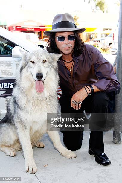 Actor/artist Richard Grieco poses for a photo with Ranger a wolf from the Wolfconnection.org at Richard Grieco's opening night gala for his one-man...