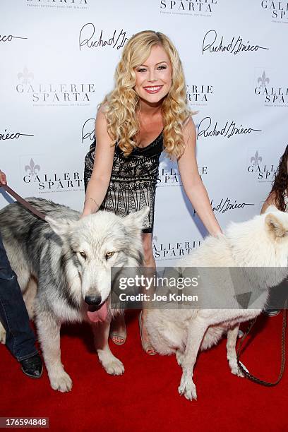 Actress Kim Poirier poses for a photo with Ranger and Maya, wolfs from the Wolfconnection.org at Richard Grieco's opening night gala for his one-man...