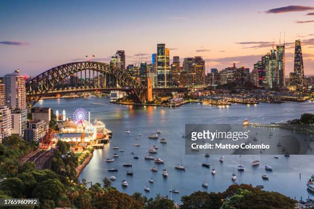 skyline at sunset with harbour bridge, sydney - sydney harbour bridge night stock pictures, royalty-free photos & images