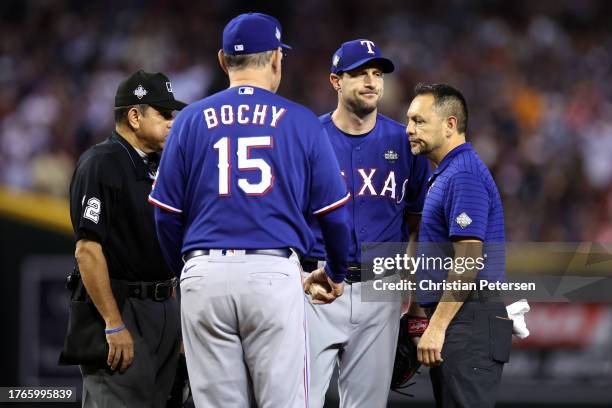 Manager Bruce Bochy of the Texas Rangers relieves Max Scherzer in the fourth inning due to injury in the fourth inning against the Arizona...