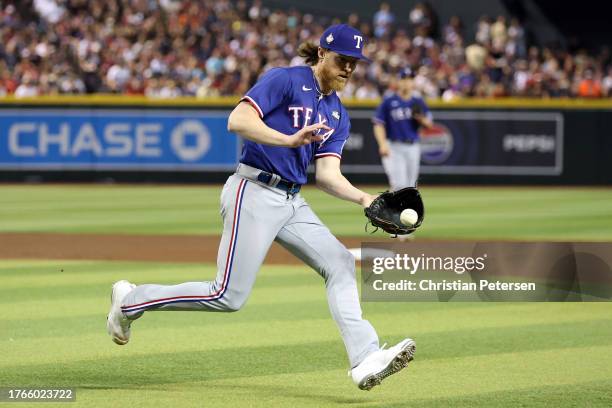 Jon Gray of the Texas Rangers fields a ground ball in the fifth inning against the Arizona Diamondbacks during Game Three of the World Series at...