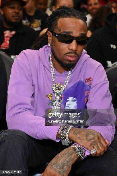 Rapper Quavo sits court-side during the game between the Minnesota Timberwolves and the Atlanta Hawks at State Farm Arena on October 30, 2023 in...