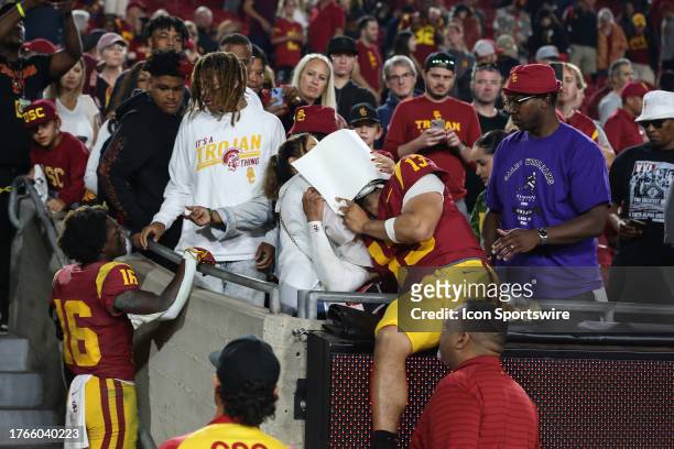 Trojans quarterback Caleb Williams shares a moment with his family after being defeated by the Washington Huskies on November 04 at the Los Angeles...