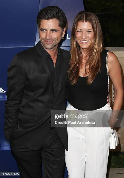 Actors John Stamos and Kate Walsh attend the Delta Air Lines summer celebration In Beverly Hills on August 15, 2013 in Beverly Hills, California.