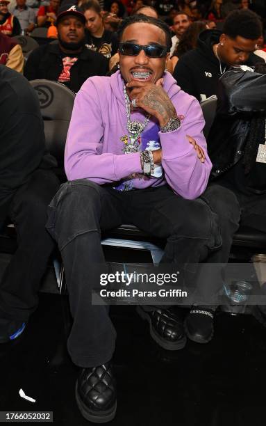Rapper Quavo sits courtside during the game between the Minnesota Timberwolves and the Atlanta Hawks at State Farm Arena on October 30, 2023 in...