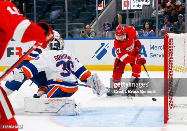 Compher of the Detroit Red Wings scores a third period goal against Ilya Sorokin of the New York Islanders at UBS Arena on October 30, 2023 in...