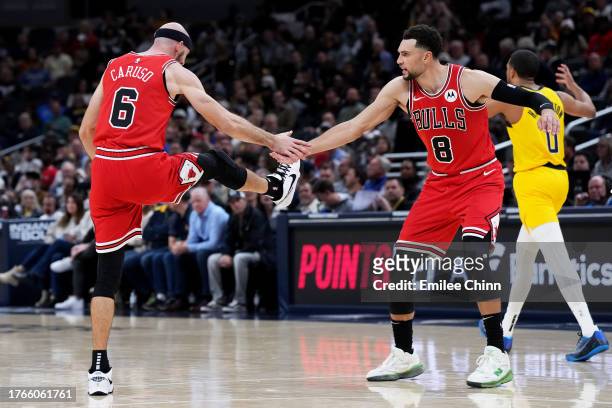 Alex Caruso of the Chicago Bulls celebrates his dunk with Zach LaVine during the second half against the Indiana Pacers at Gainbridge Fieldhouse on...