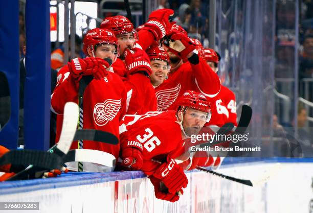 The Detroit Red Wings celebrate a third period goal by J.T. Compher against the New York Islanders at UBS Arena on October 30, 2023 in Elmont, New...