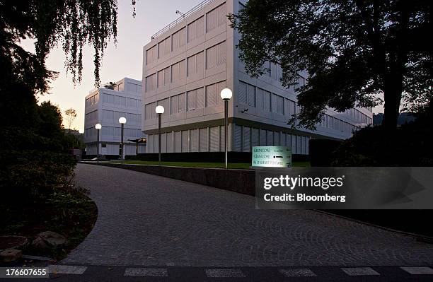 Lights illuminate a sign at the entrance to Glencore Xstrata Plc's headquarters in Baar, Switzerland, on Thursday, Aug. 15, 2013. Glencore Xstrata,...