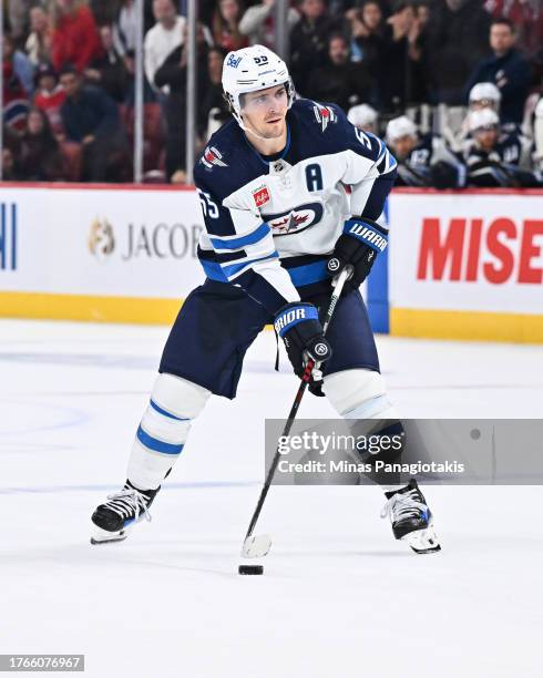 Mark Scheifele of the Winnipeg Jets skates the puck during the shootout against the Montreal Canadiens at the Bell Centre on October 28, 2023 in...