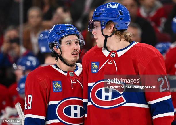 Rafael Harvey-Pinard of the Montreal Canadiens and teammate Kaiden Guhle talk during the third period against the Winnipeg Jets at the Bell Centre on...