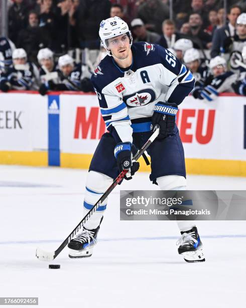 Mark Scheifele of the Winnipeg Jets skates the puck during the shootout against the Montreal Canadiens at the Bell Centre on October 28, 2023 in...