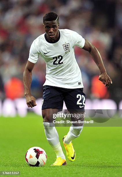 Wilfried Zaha of England runs with the ball during the International Friendly match between England and Scotland at Wembley Stadium on August 14,...