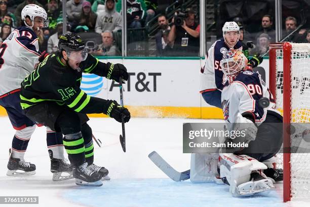 Elvis Merzlikins of the Columbus Blue Jackets watches as a shot from Craig Smith of the Dallas Stars is deflected wide of the net during the third...