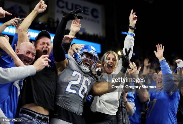 Jahmyr Gibbs of the Detroit Lions celebrates his touchdown with fans in the third quarter against the Las Vegas Raiders at Ford Field on October 30,...