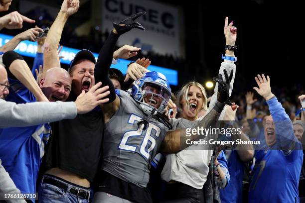 Jahmyr Gibbs of the Detroit Lions celebrates his touchdown with fans in the third quarter against the Las Vegas Raiders at Ford Field on October 30,...