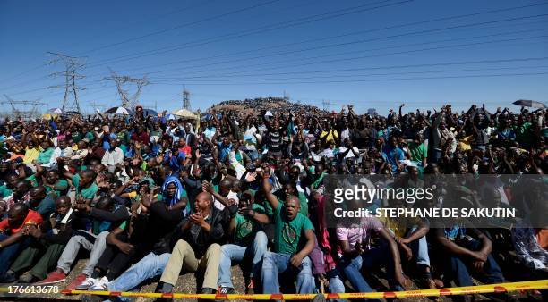 Co-workers of 34 miners shot dead by South African police during a violent wage strike attend a ceremony to mark the first anniversary of their...