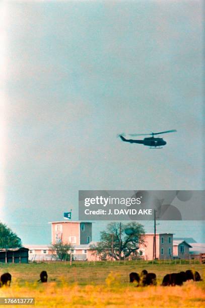 National Guard helicopter circles the Branch Davidian religious compound in Waco on April 17, 1993 as the armed stand off between the religious cult...