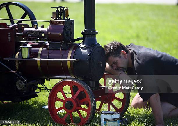 An exhibitor prepares a miniature steam engine to show at the Cornish Steam and Country Fair at the Stithians Showground on August 16, 2013 near...