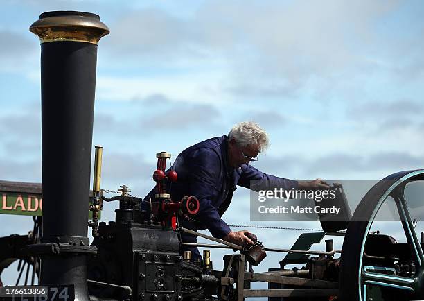 An exhibitor prepares a steam engine to show at the Cornish Steam and Country Fair at the Stithians Showground on August 16, 2013 near Penryn,...