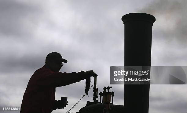 An exhibitor prepares a steam engine to show at the Cornish Steam and Country Fair at the Stithians Showground on August 16, 2013 near Penryn,...