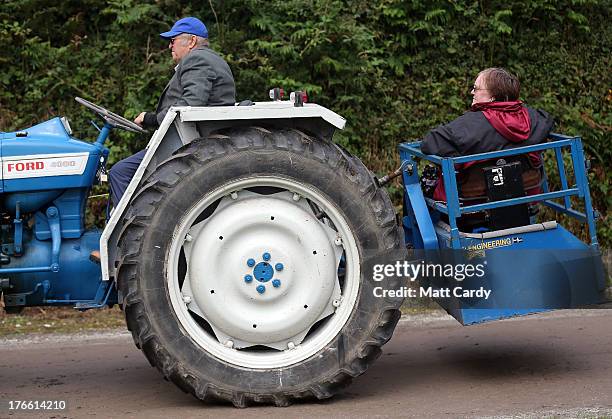 An exhibitor drives his tractor into the showground at the Cornish Steam and Country Fair at the Stithians Showground on August 16, 2013 near Penryn...