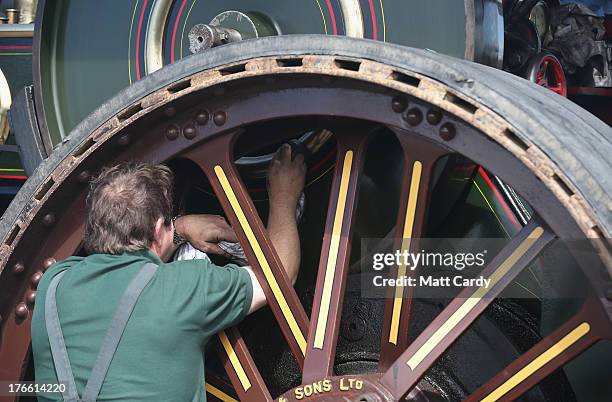 An exhibitor prepares a steam engine to show at the Cornish Steam and Country Fair at the Stithians Showground on August 16, 2013 near Penryn,...