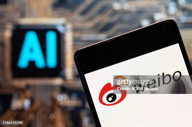 In this photo illustration, the Chinese social media platform Weibo logo seen displayed on a smartphone with an Artificial intelligence chip and...