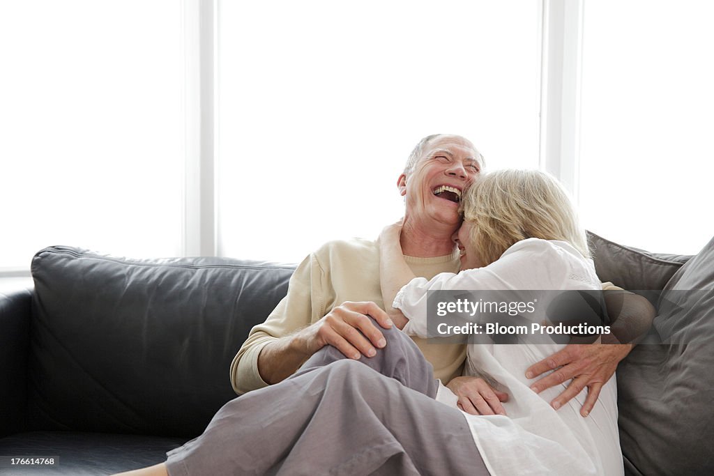 Mature couple laughing and cuddling