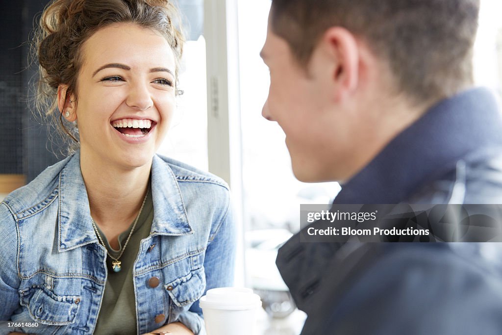 Late teens girl and boy laughing