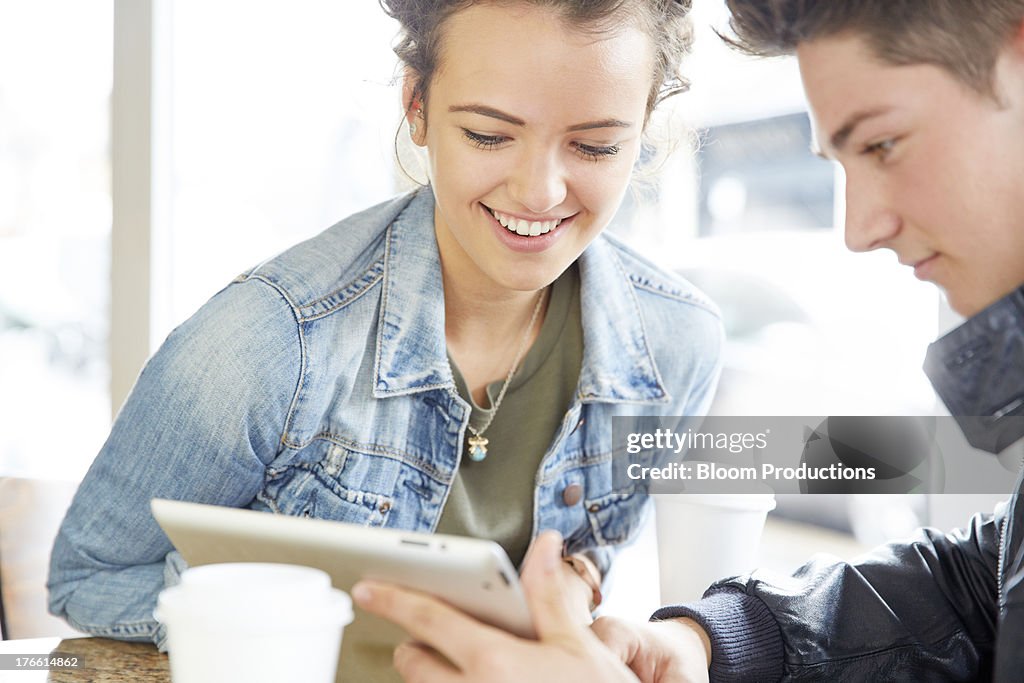 Late Teens boy and girl using a tablet