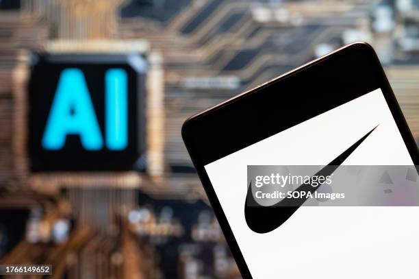 In this photo illustration, the American multinational sports clothing brand Nike logo seen displayed on a smartphone with an Artificial intelligence...