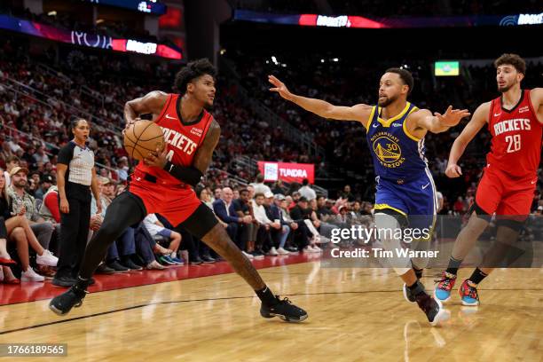 Jalen Green of the Houston Rockets steps back to shoot while defended by Stephen Curry of the Golden State Warriors in the first half at Toyota...