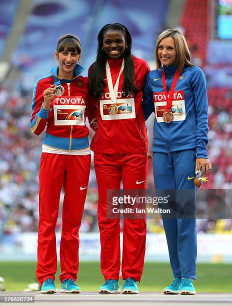 Silver medalist Ekaterina Koneva of Russia, gold medalist Caterine Ibarguen of Colombia and bronze medalist Olha Saladuha of Ukraine stand on the...